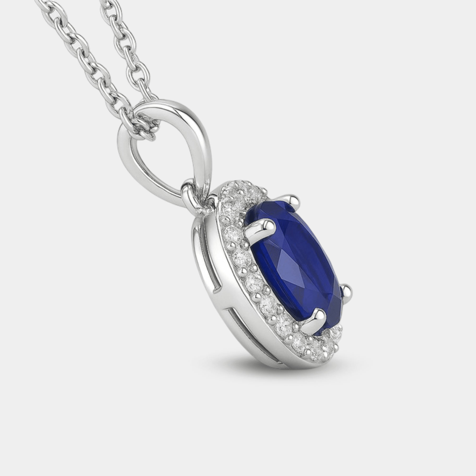 Blue sapphire halo pendant shown on its 18-inch sterling silver chain