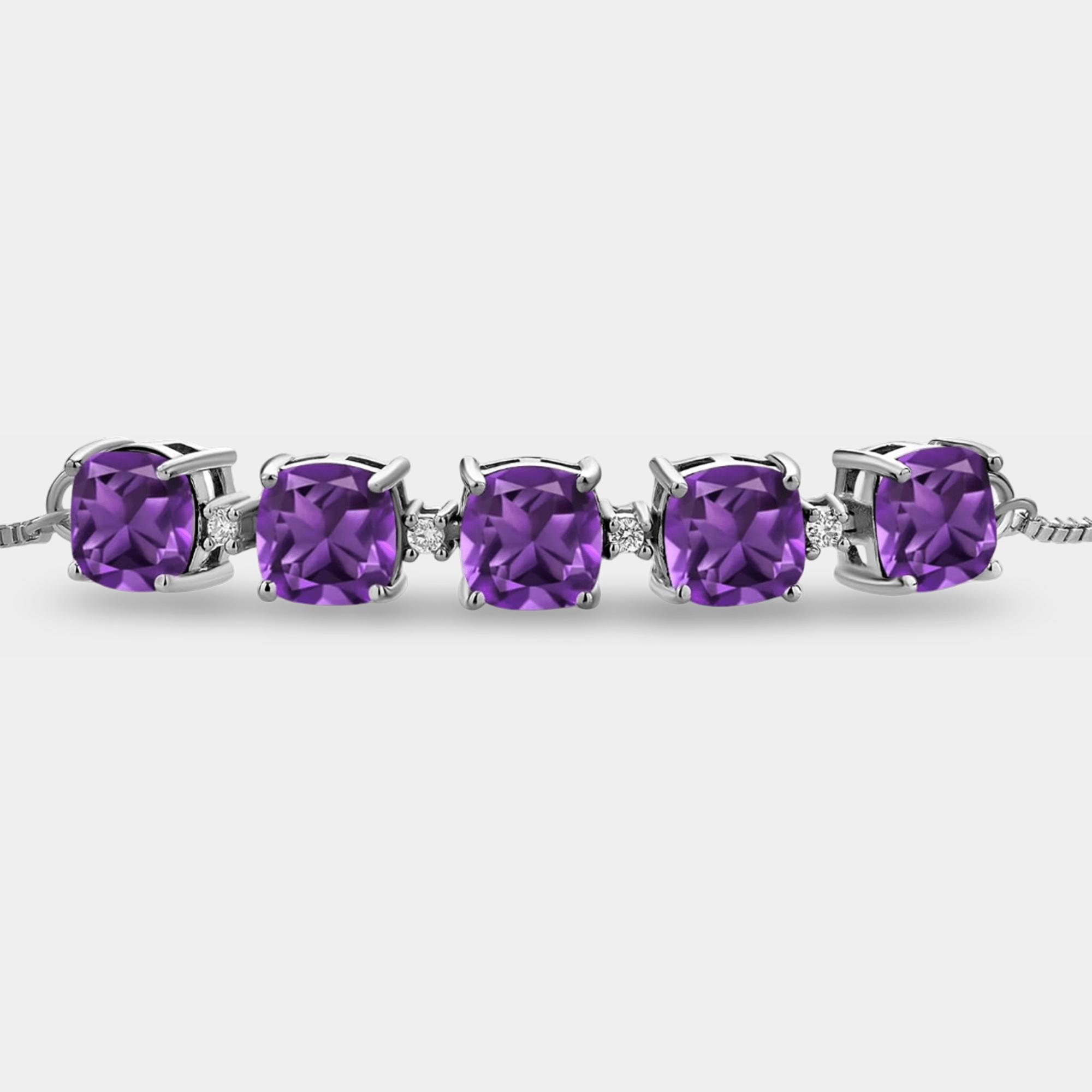Macro detail shot of the Sena Amethyst Cushion Tennis Bracelet highlighting the cushion-cut amethyst gemstones and small diamond accents set in sterling silver prongs