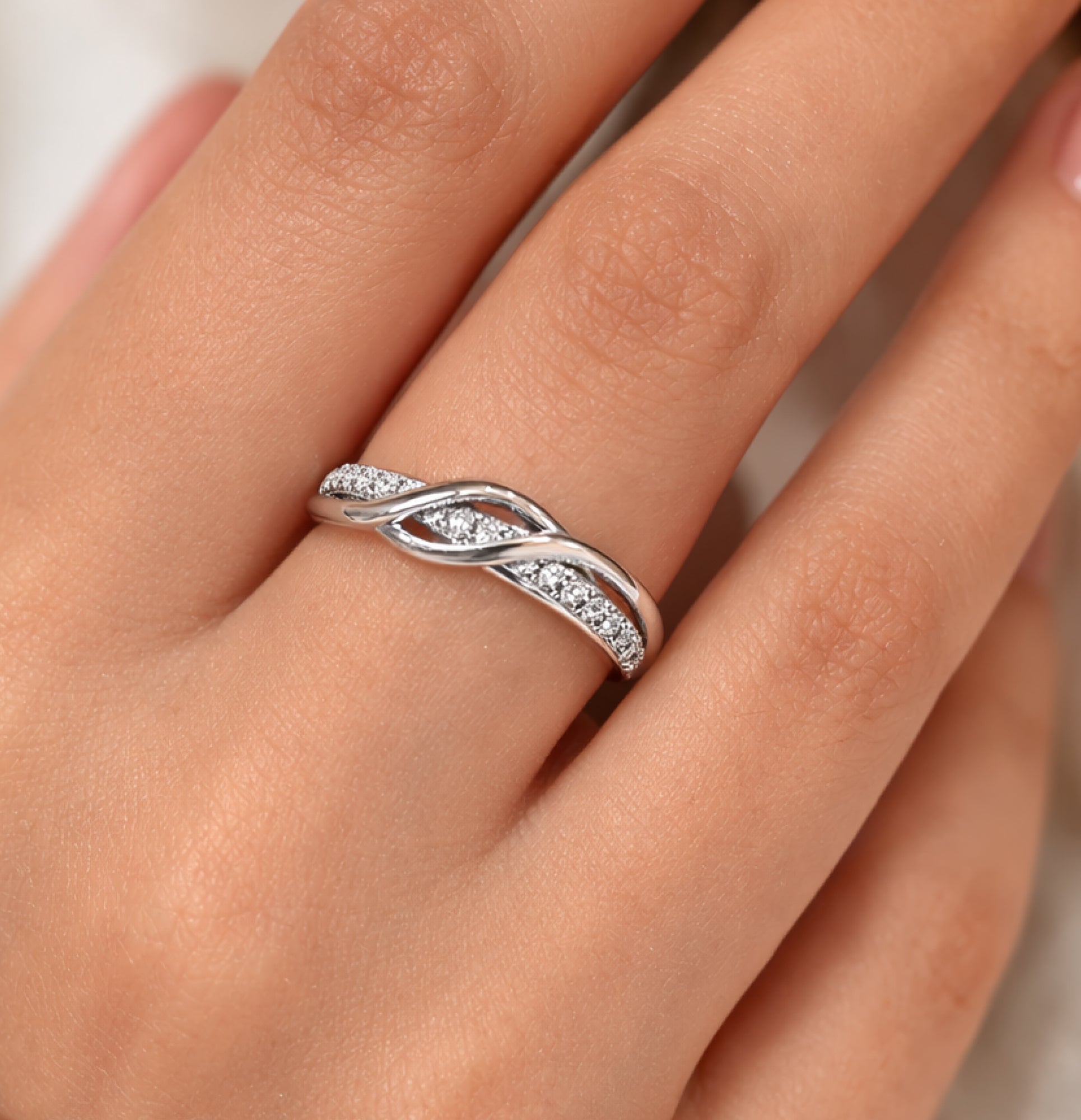 316L stainless steel infinity knot ring shown at an angle to show the sparkle