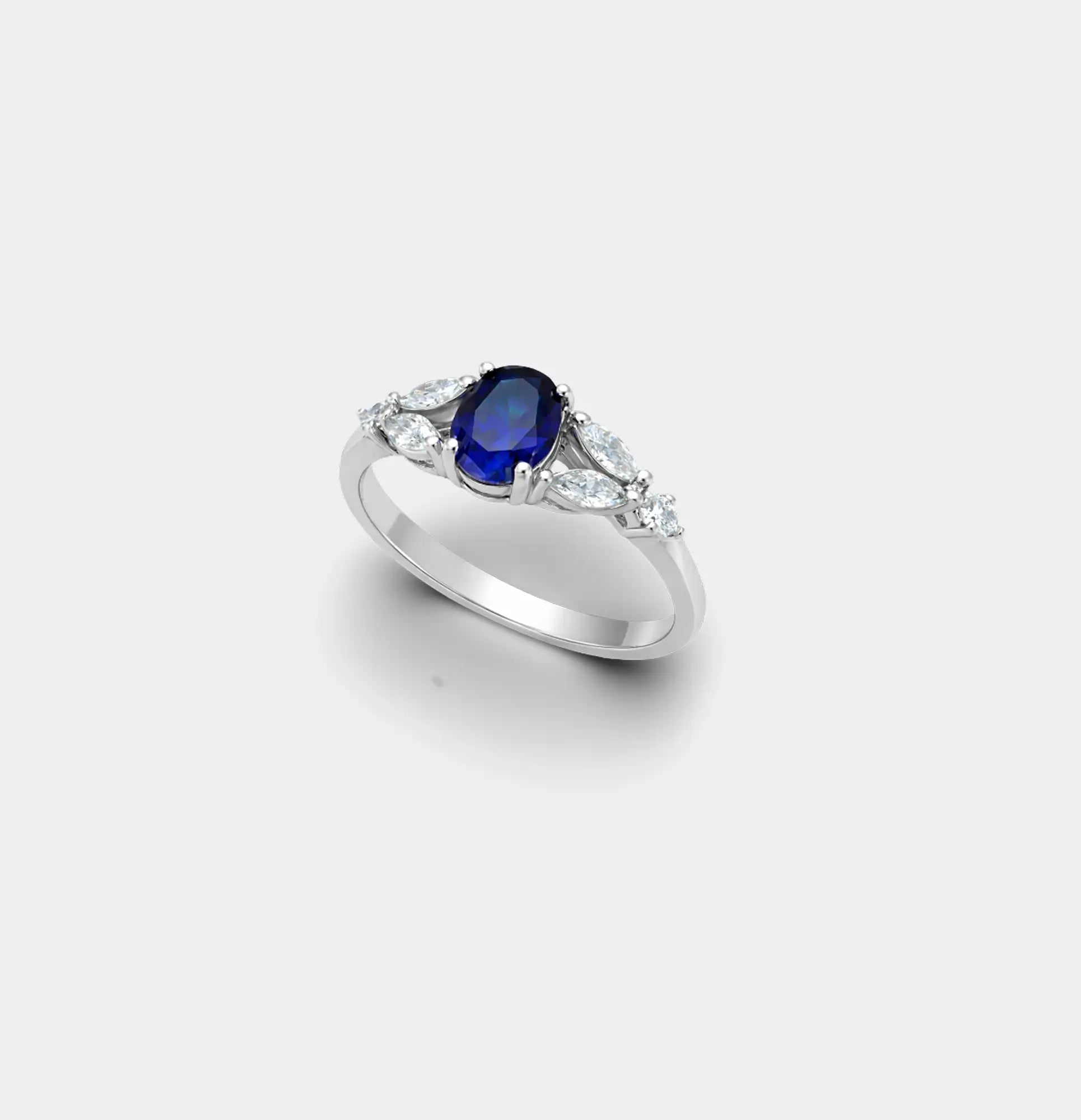 Side view of the oval blue sapphire ring showing the halo and accent stones