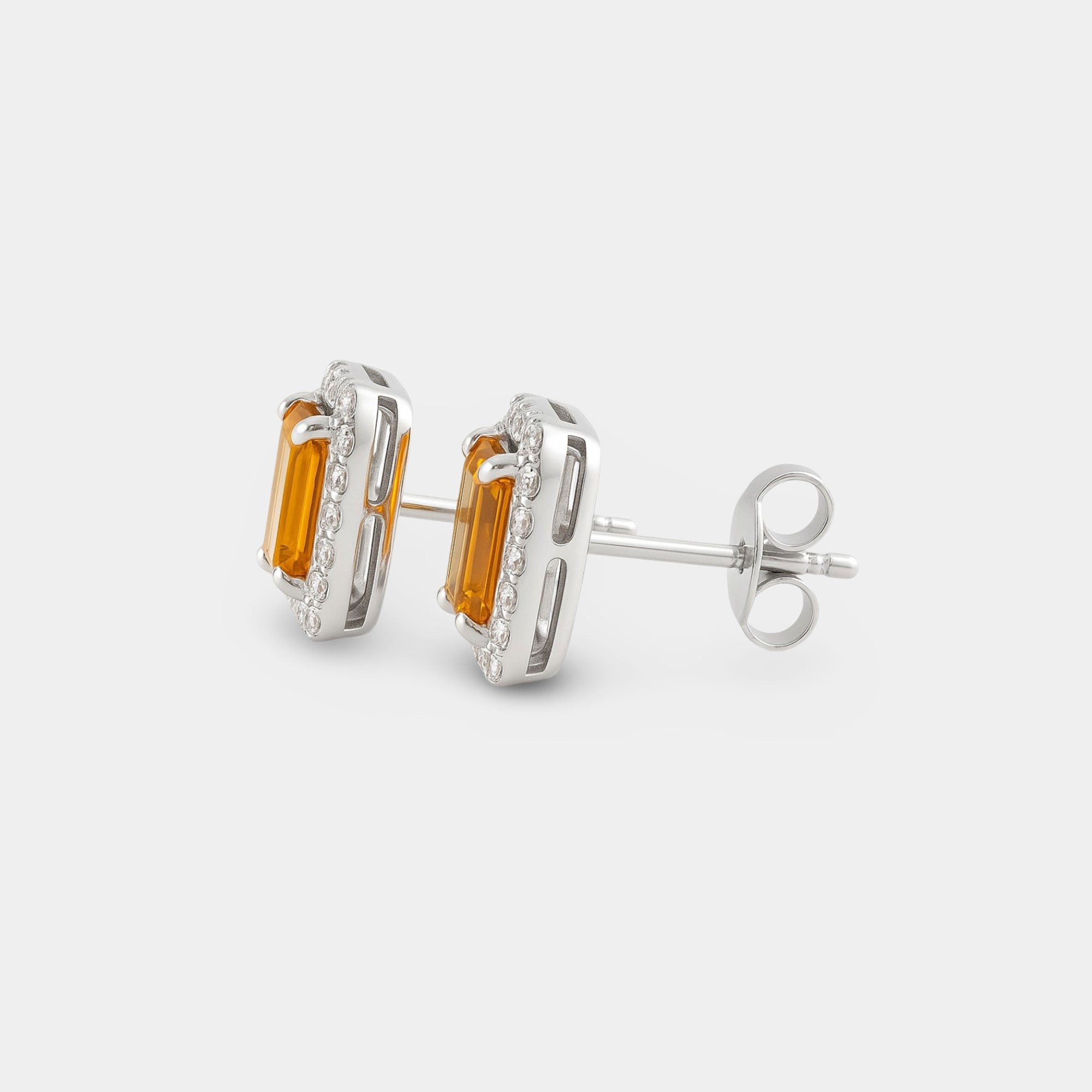 Pair of sterling silver citrine halo earrings shown side by side.