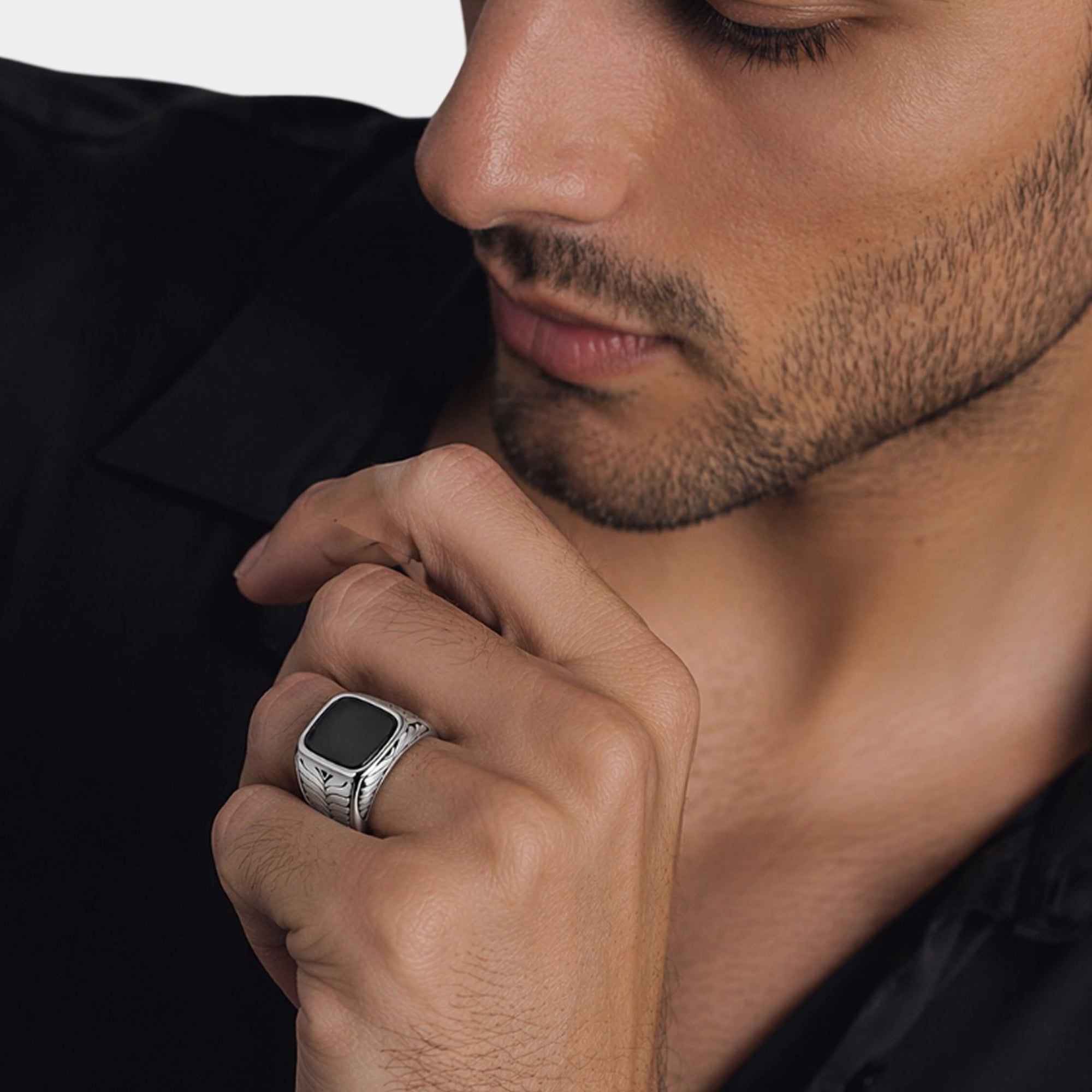 Close-up of the smooth black onyx stone on a silver men's ring
