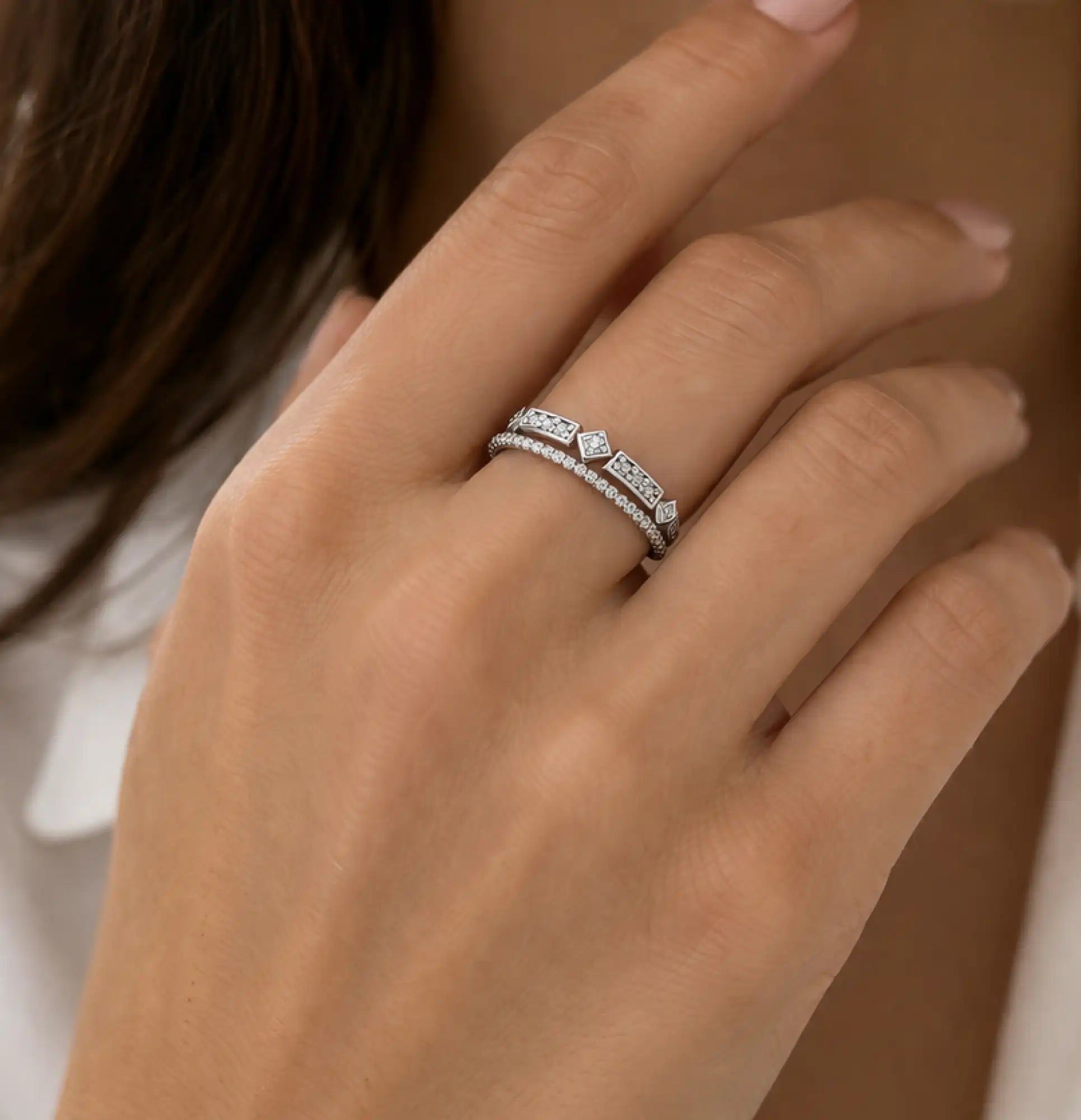 Close-up of a double row moissanite anniversary band in 925 sterling silver on a woman's finger