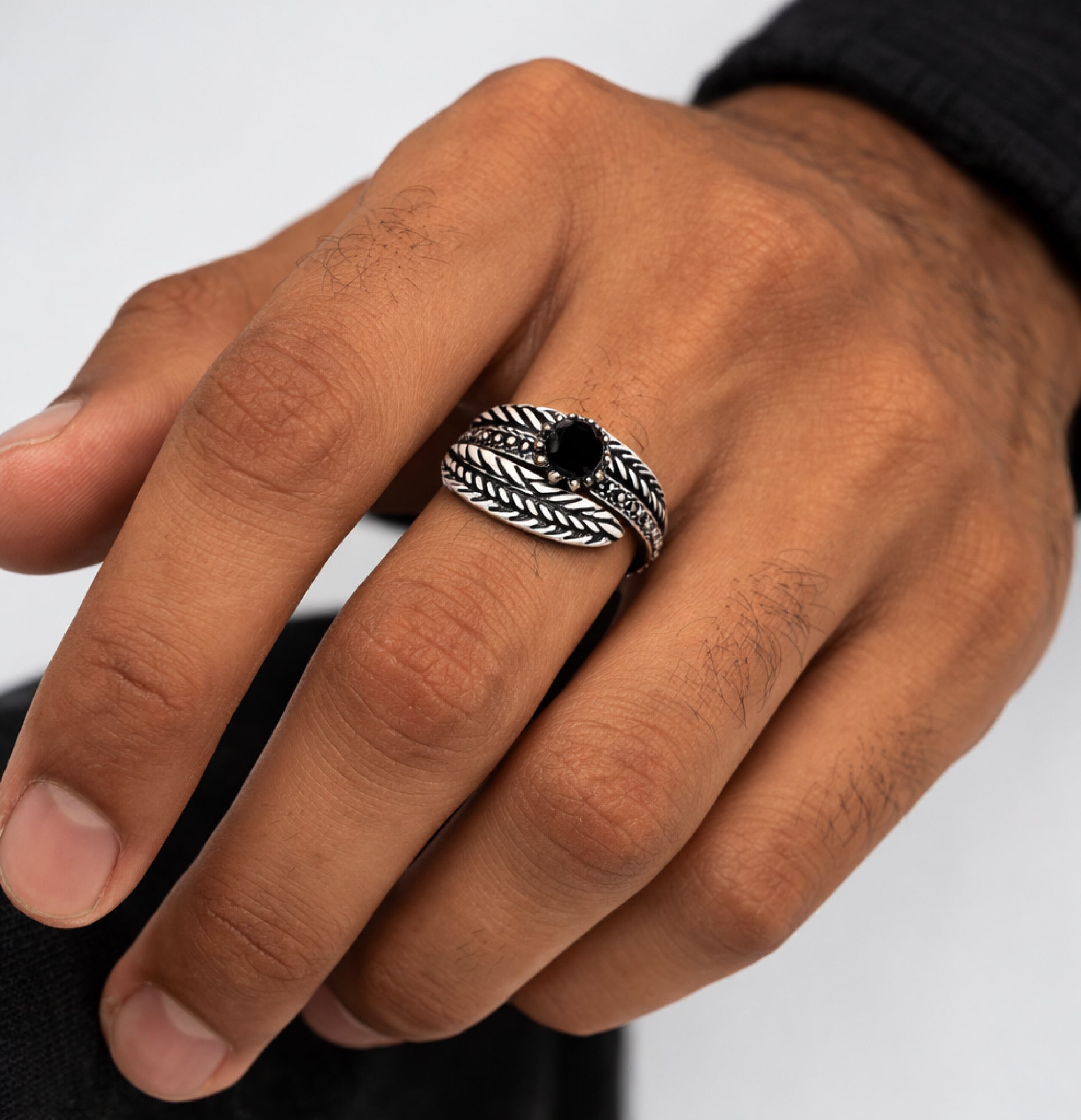 Close view of the black onyx stone on the sterling silver feather ring
