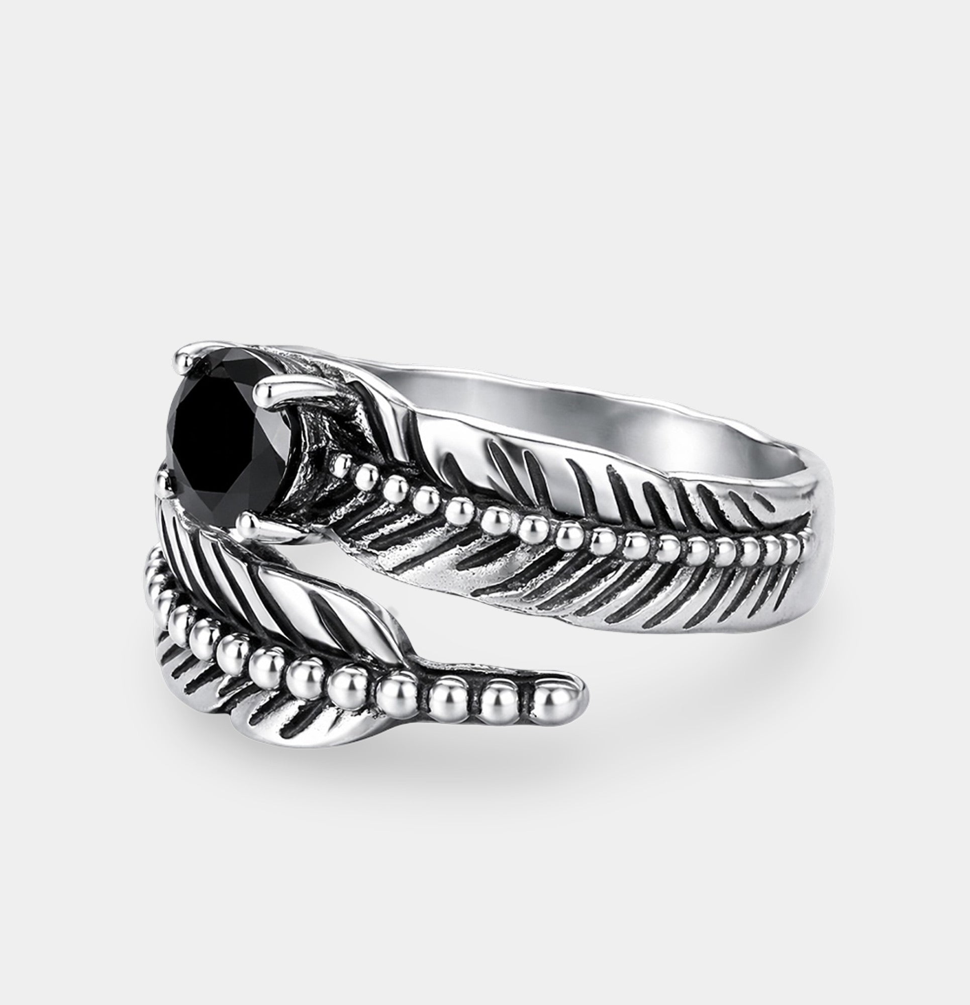 Adjustable open sterling silver black onyx feather ring shown from the side