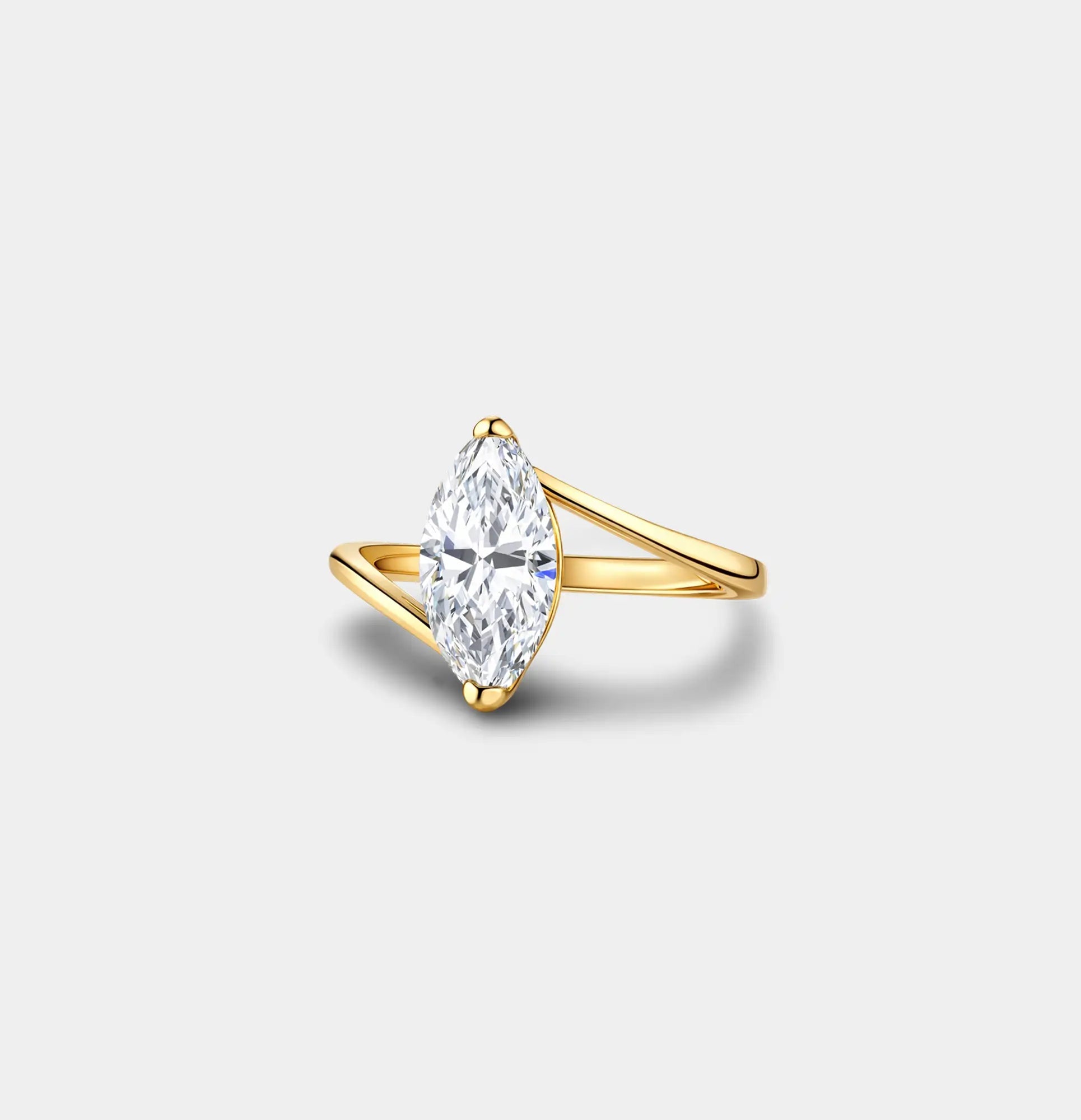 Three-quarter view of a gold marquise solitaire promise ring with the stone set north to south