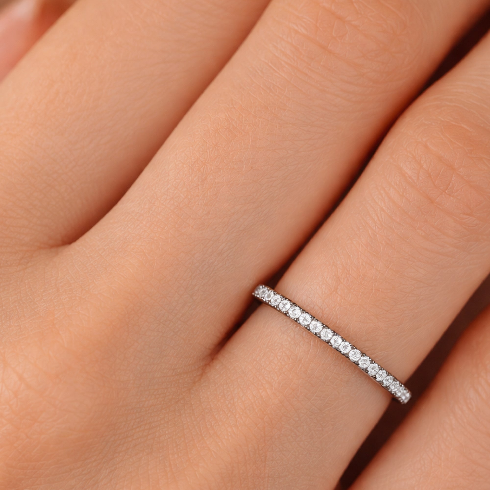 Close-up of the black and multicolor CZ stones on a silver eternity ring