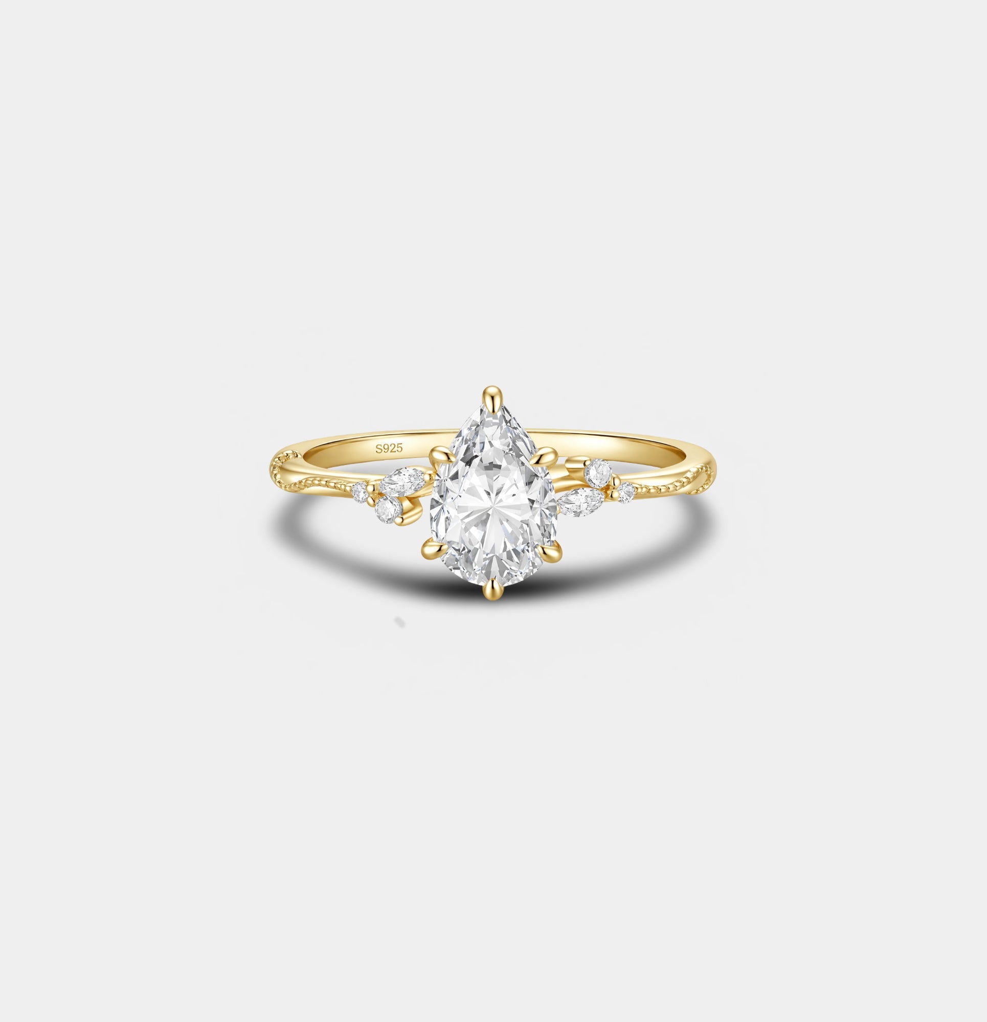 Gold-tone pear cut cubic zirconia halo engagement ring, front view