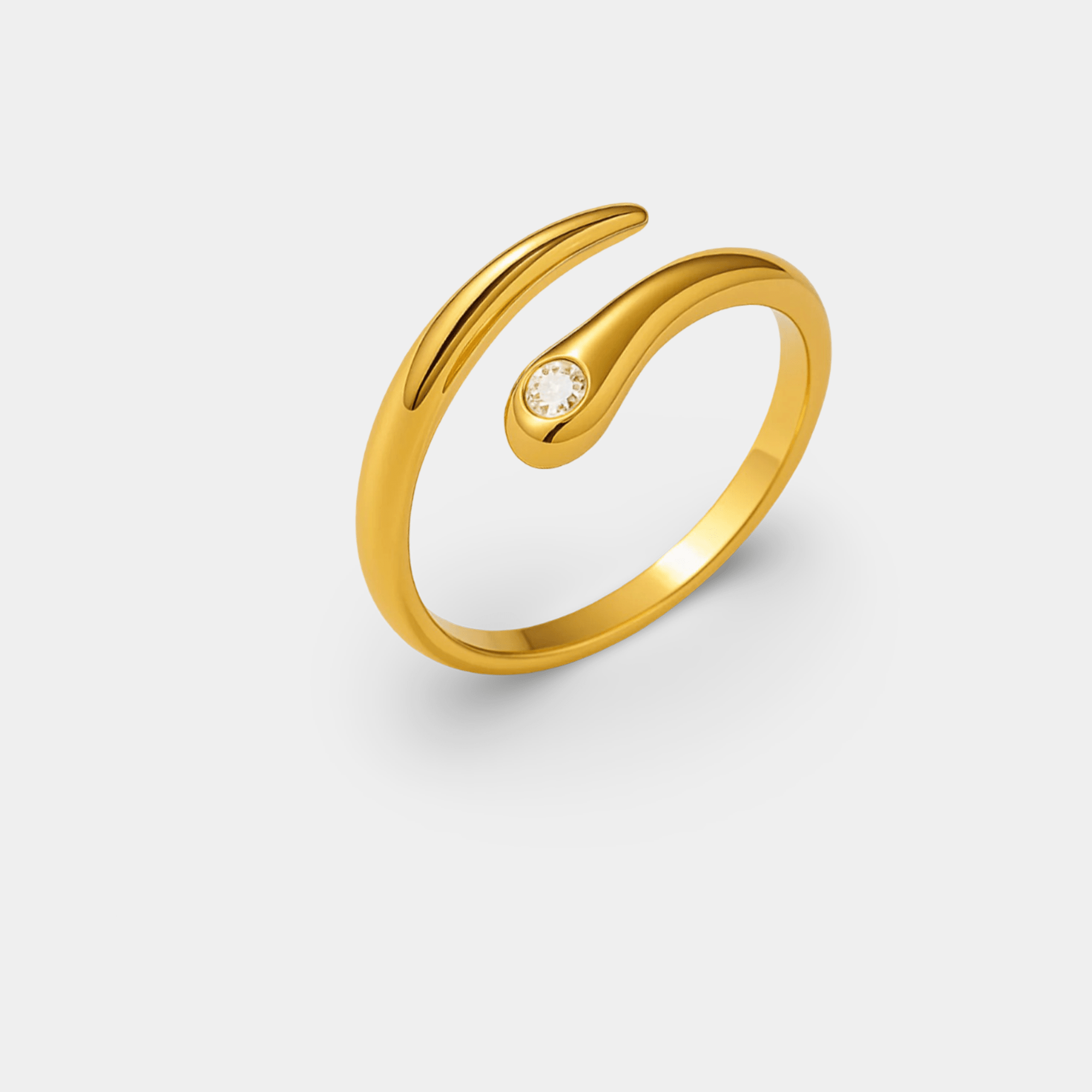 Close-up of the twisted wave band and bezel-set CZ stone on the adjustable gold wrap ring