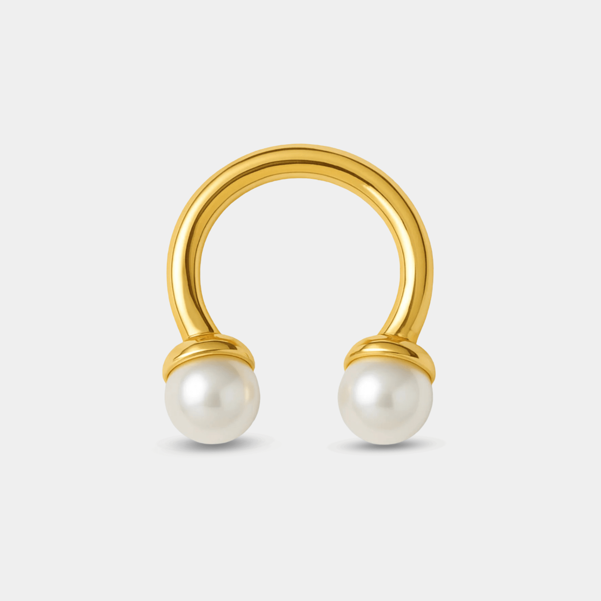 Side angle of the adjustable open band on the gold twin pearl arc ring showing the geometric arc design