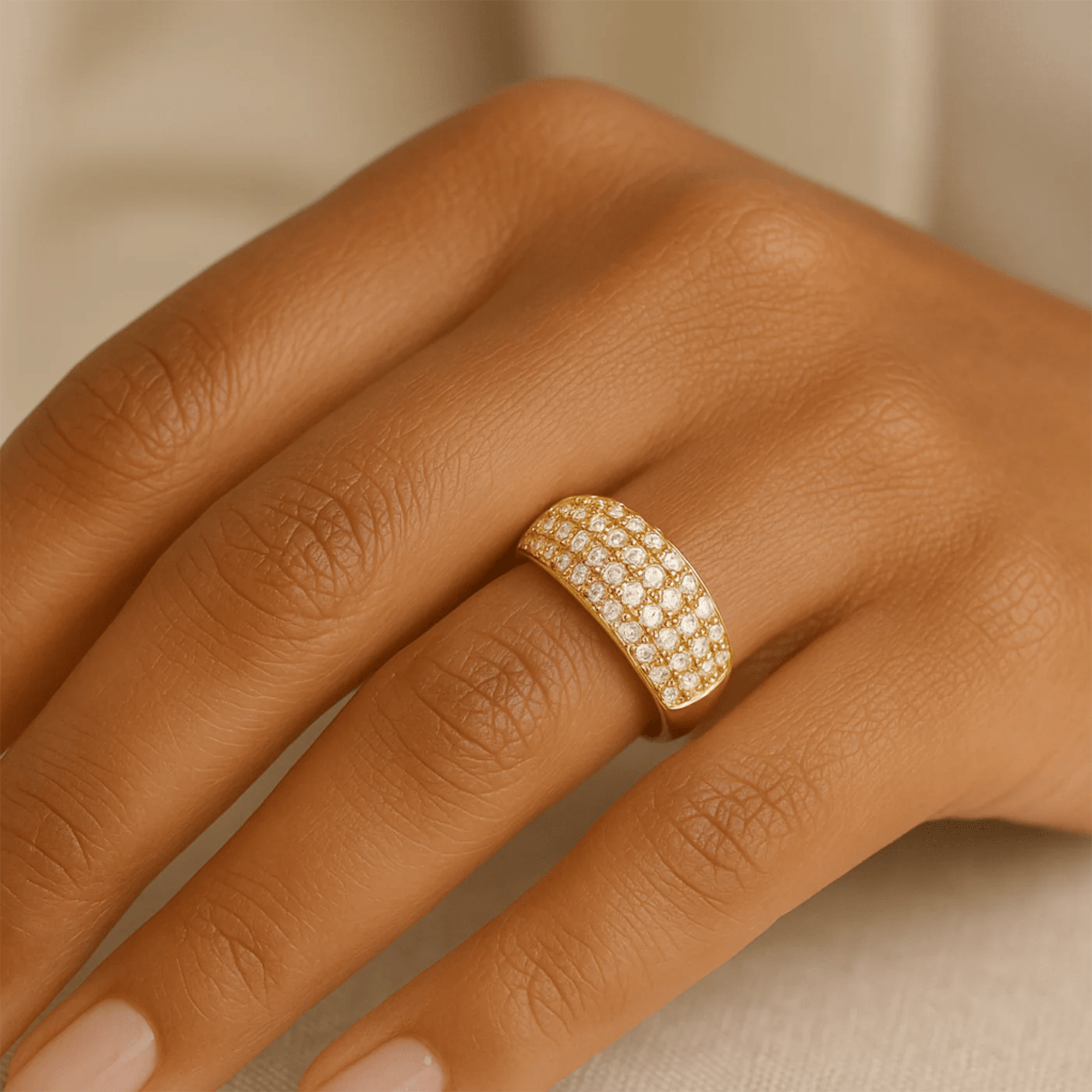 Close-up of the Veloura pavé CZ ring worn on a hand, showing the gold setting detail