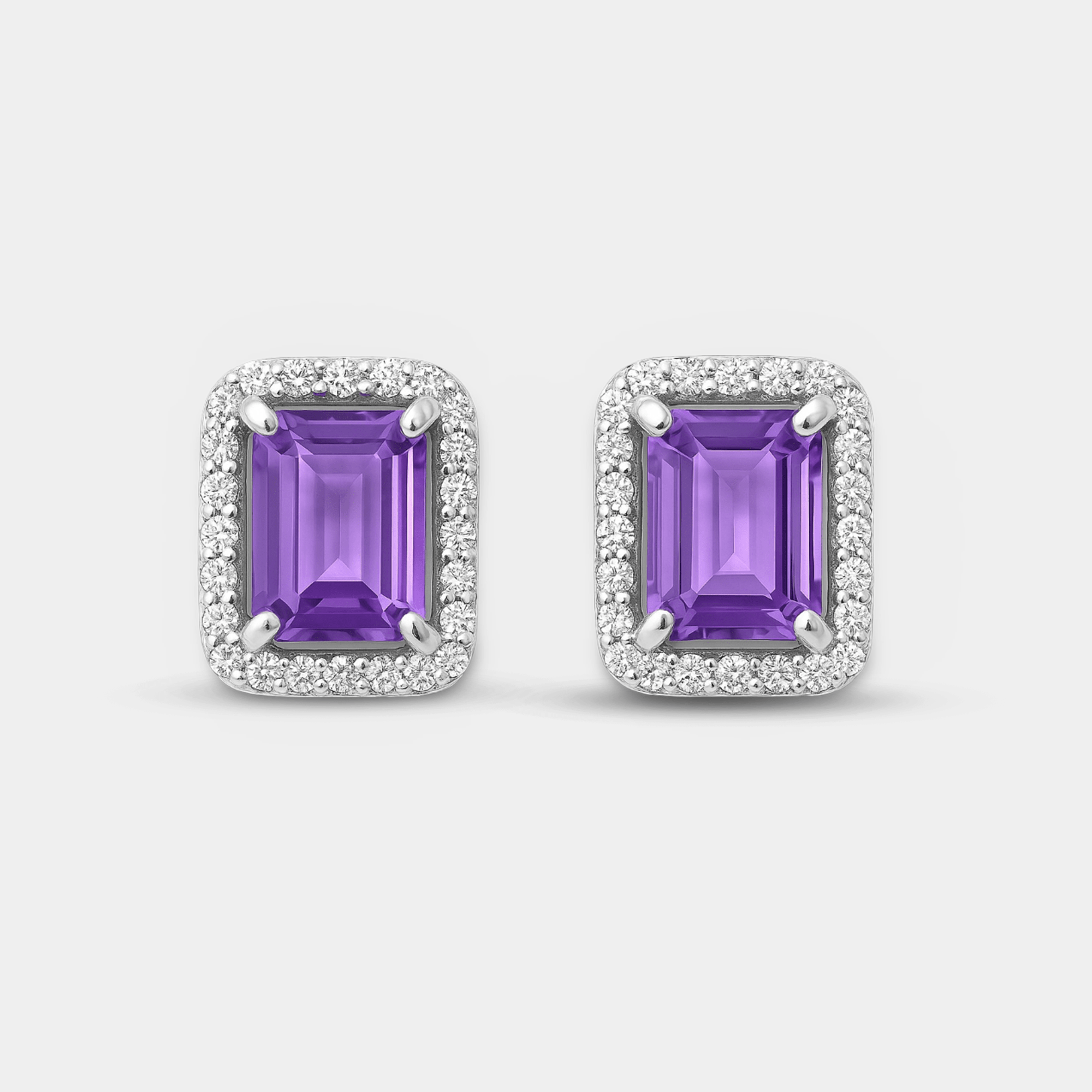 Front view of both emerald-cut amethyst halo stud earrings with sparkling cubic zirconia halos in sterling silver