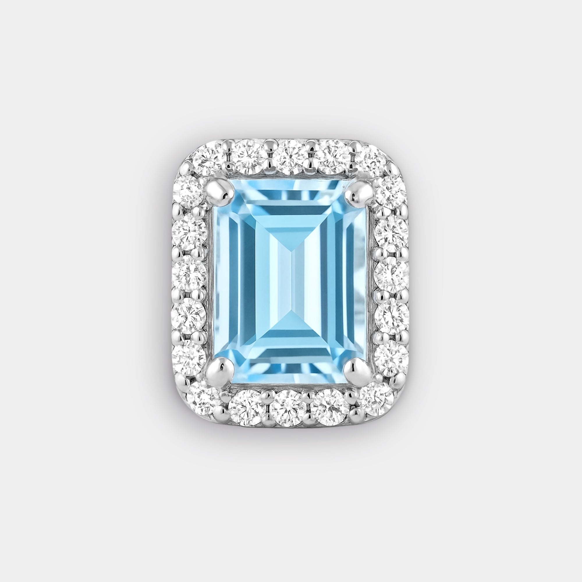 Close-up of one emerald-cut sky blue aquamarine framed by a cubic zirconia halo in sterling silver